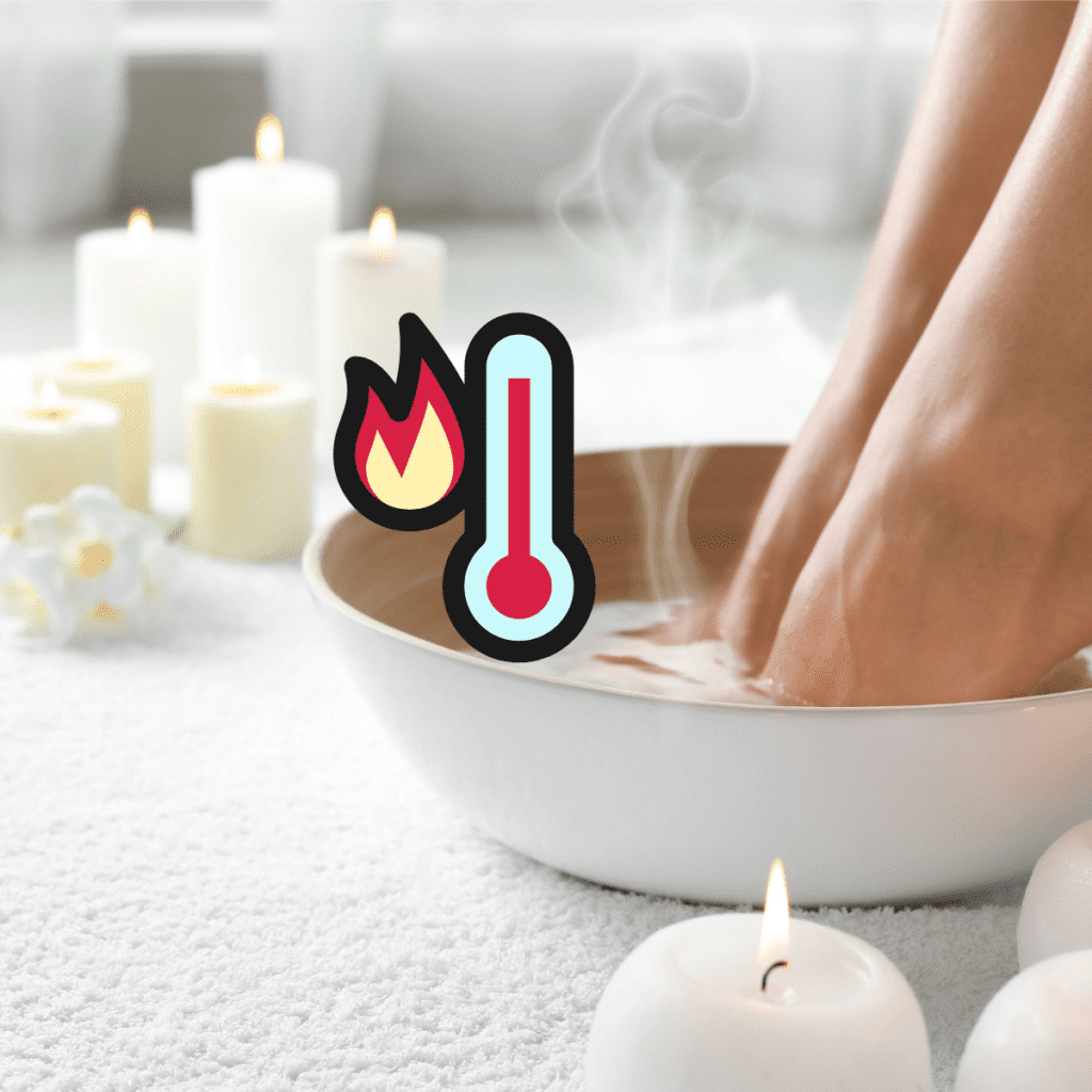 Calm salon floor with white and yellow candles and flowers, a carpet, and a white and brown bowl of water. Pedicure client places feet in the water, near hovering steam and a graphic of a red thermometer. Portrays the risks and dangers of nail salon burns from hot water.