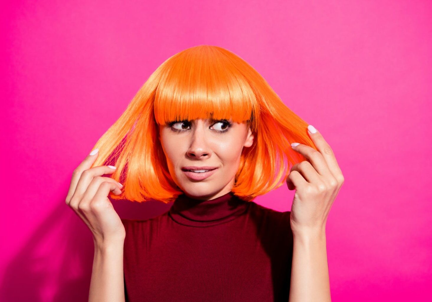 Woman looks bewildered at her short, botched red hair as if considering hair salon lawsuits. A hair color consultation form can prevent bad hair dye and color job claims and these pictures of bad hair dye jobs.