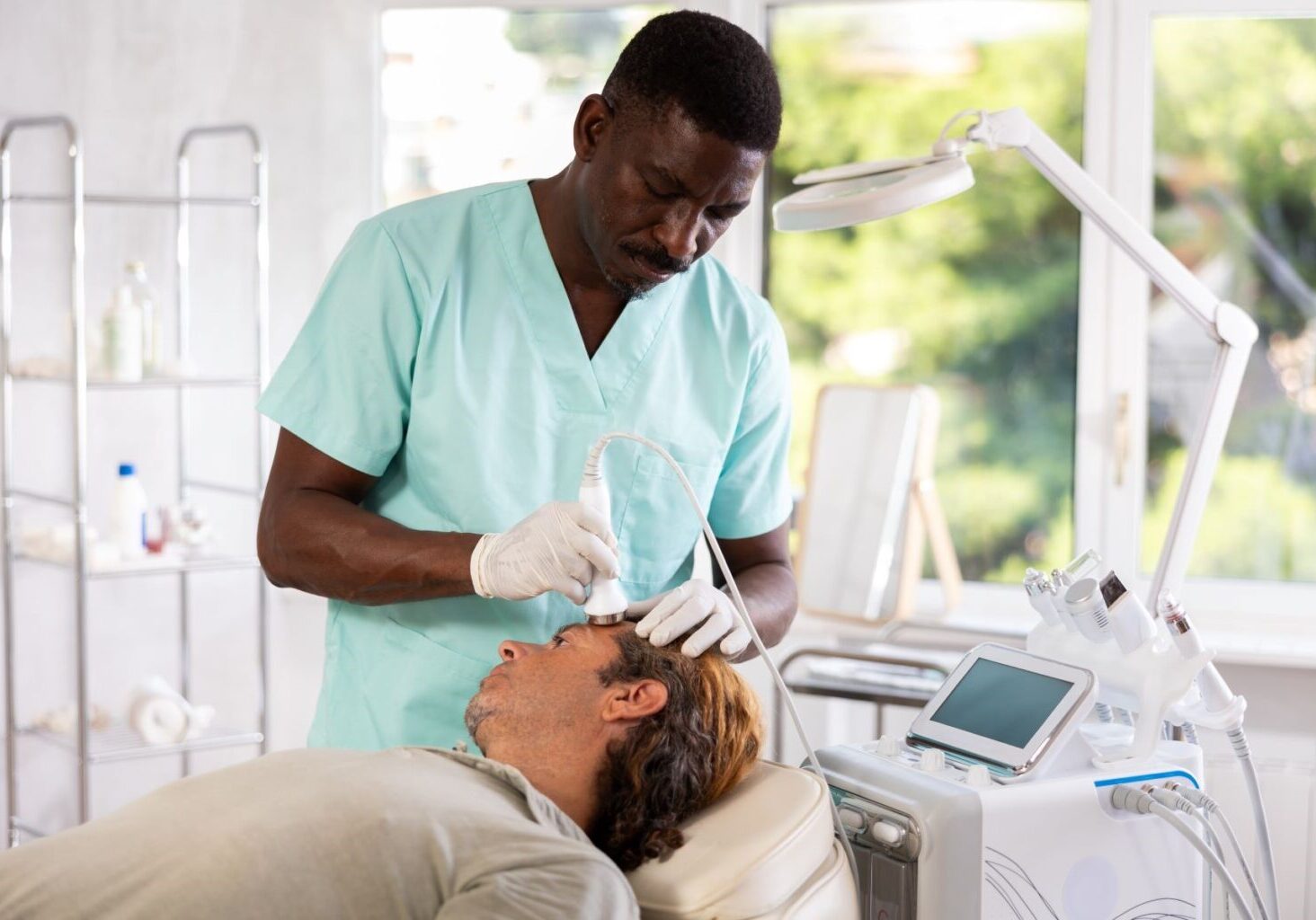 Male esthetician performs anti-aging procedure on male client at cosmetic clinic. Working with upset clients is one of many challenges of being an esthetician.