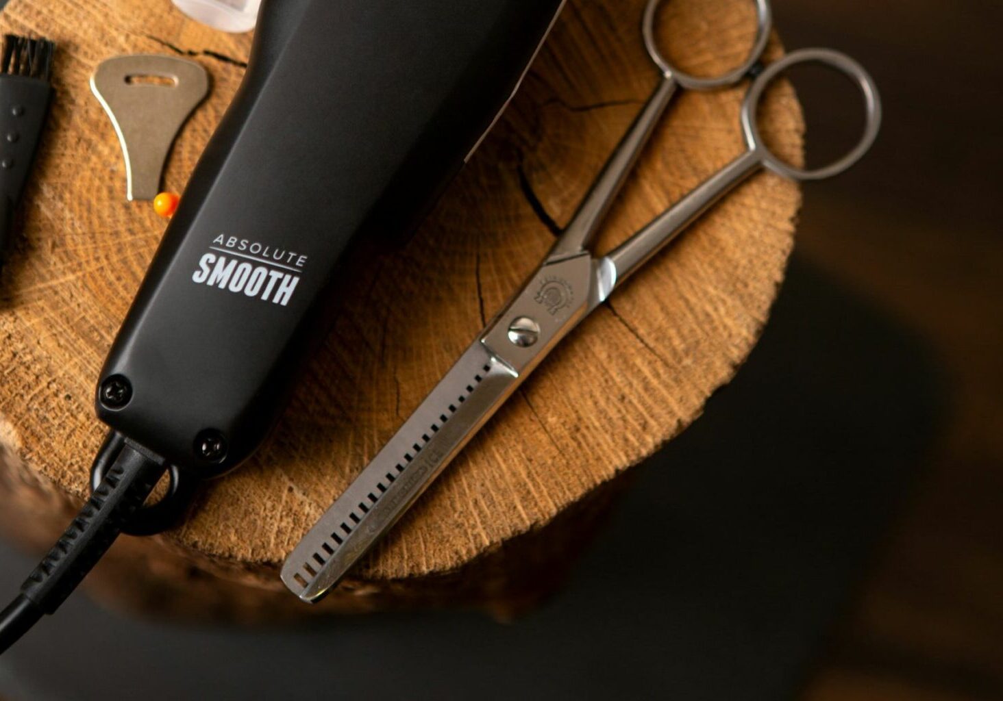 A barber’s beard trimmer and electric razor posed next to a pair of hair thinning shears.